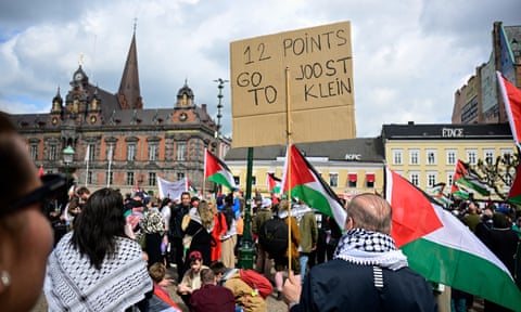 Charged atmosphere … a pro-Palestinian demonstrator holds a ‘12 Points to Joost Klein’ in Malmö.