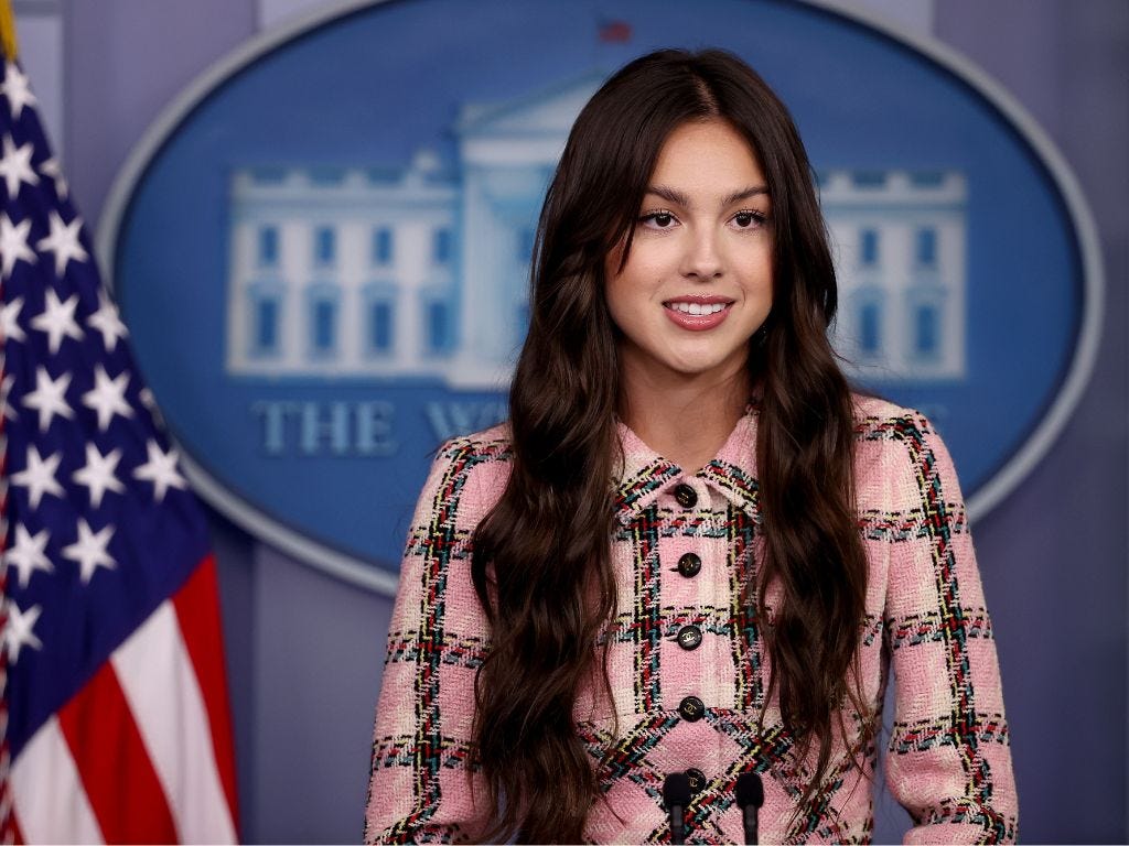 Olivia Rodrigo talking to reporters at the White House.