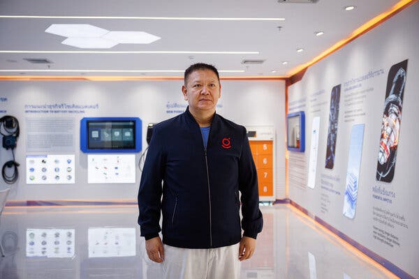 Huang Yongjie standing inside a showroom, wearing a navy jacket. 