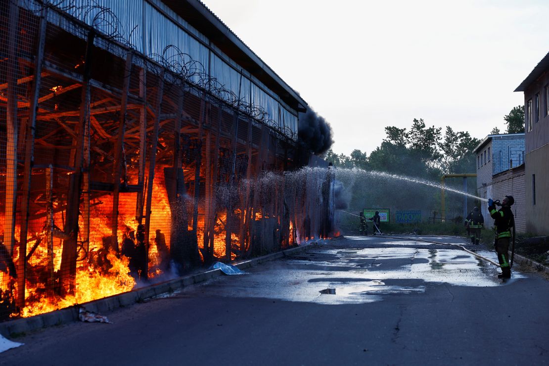 Firefighters work at a hardware store targeted by a Russian air strike in Kharkiv, May 25, 2024.